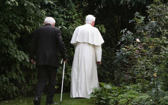 Pope Benedict XVI and his brother, Msgr. Georg Ratzinger, take a walk through the garden of a house the pope owns in Pentling, near Regensburg, Germany, Sept. 13, 2006. Pope Benedict died Dec. 31, 2022, at the age of 95 in his residence at the Vatican. 
