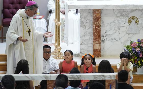 San Antonio Archbishop Gustavo García-Siller talks with children as President Joe Biden and first lady Jill Biden attend Mass at Sacred Heart Catholic Church May 29 in Uvalde, Texas, after the murder of 19 children and two teachers in an elementary school shooting May 24 in Uvalde. (AP photo/Evan Vucci)
