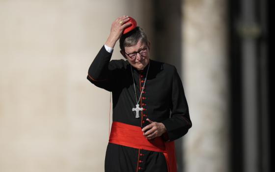 Cardinal Rainer Maria Woelki adjusts his red zucchetto