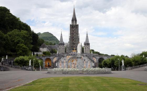 A gray Cathedral with scaffolding around one of its towers