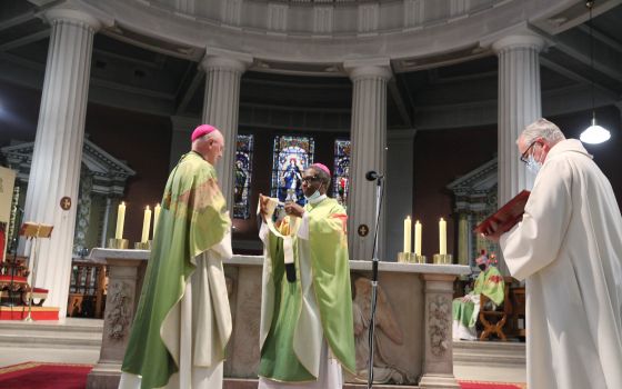 Dublin Archbishop Dermot Farrell receives his pallium from Archbishop Jude Thaddeus Okolo, papal nuncio, center, at St. Mary's Pro Cathedral in Dublin Aug. 7, 2021. (CNS photo/courtesy John McElroy)