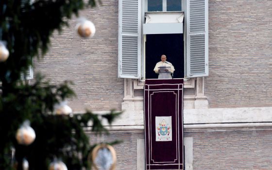 The Christmas tree is seen as Pope Francis leads the Angelus from the window of his studio overlooking St. Peter's Square at the Vatican Jan. 9, 2022. (CNS photo/Vatican Media)