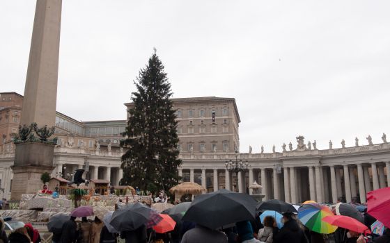 The Christmas tree is seen as Pope Francis leads the Angelus from the window of his studio overlooking St. Peter's Square at the Vatican Jan. 9, 2022. The pope prayed for peace in Kazakhstan. (CNS photo/Vatican Media)