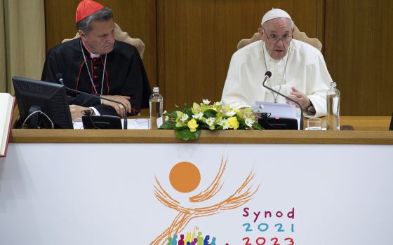 Pope Francis speaks as Maltese Cardinal Mario Grech, secretary-general of the Synod of Bishops, looks on during a meeting with representatives of bishops' conferences from around the world at the Vatican in this Oct. 9, 2021. (CNS photo/Paul Haring)