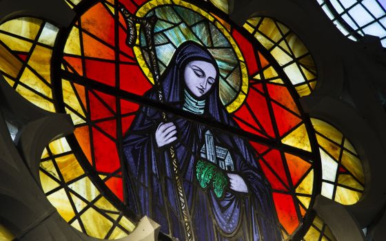 St. Brigid of Kildare is pictured in a stained-glass window in St. Brigid's Church Jan. 20 in Crosshaven, a village in County Cork, Ireland. (CNS/Cillian Kelly)
