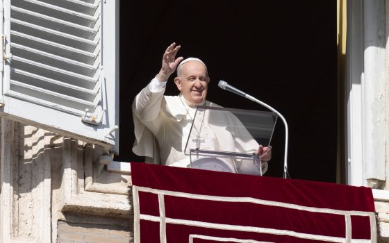 Pope Francis greets the crowd as he leads the Angelus from the window of his studio overlooking St. Peter's Square at the Vatican Jan. 23, 2022. (CNS photo/Vatican Media)