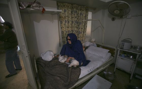 A patient sits on her bed at Marie Adelaide Leprosy Center in Karachi, Pakistan, in this Jan. 25, 2008. (CNS photo/Athar Hussain, Reuters)