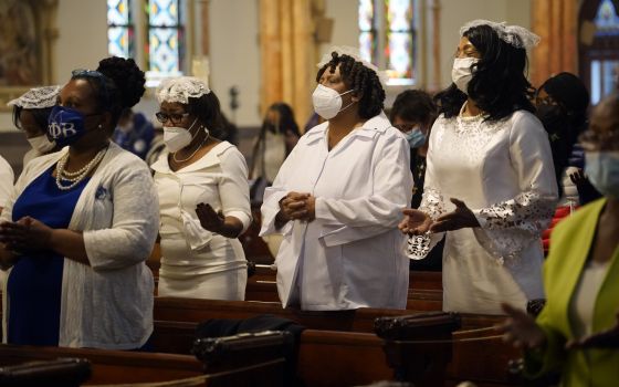 Members of the Ladies Auxiliary of the Knights of Peter Claver pray during a Mass marking Black Catholic History Month Nov. 21, 2021, at Our Lady of Victory Church in the Bedford-Stuyvesant section of Brooklyn, N.Y. (CNS photo/Gregory A. Shemitz)