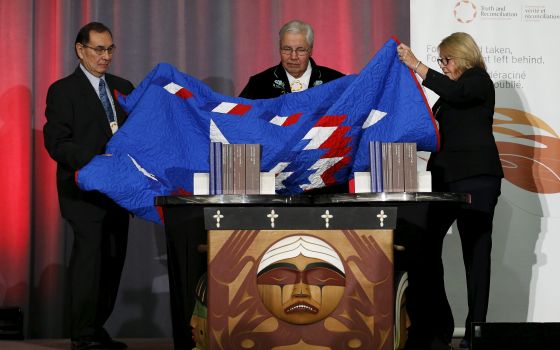 Cree Chief Wilton Littlechild, Justice Murray Sinclair and Commissioner Marie Wilson unveil the Truth and Reconciliation Commission's final report in Ottawa, Ontario, Dec. 15, 2015. (CNS photo/Chris Wattie, Reuters)
