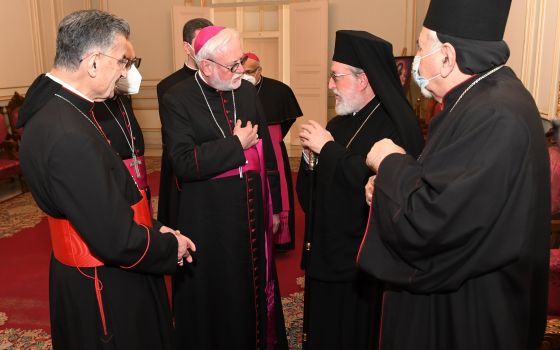 Archbishop Paul Gallagher, Vatican foreign minister, center, speaks with Metropolitan Elias Kfoury, representing Greek Orthodox Patriarch John X, Feb. 2, as they attend the monthly meeting of the Maronite Catholic bishops at Bkerke, near Beirut. (CNS)