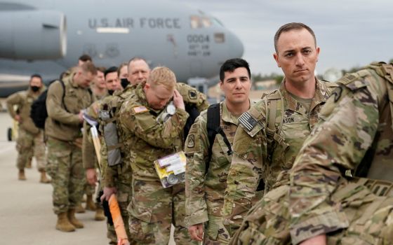 Military personnel from the 82nd Airborne Division and 18th Airborne Corps in Fort Bragg, N.C., board a C-17 transport plane for deployment to Eastern Europe Feb. 3, 2022, amid escalating tensions between Ukraine and Russia. (CNS photo/Bryan Woolston, Reu