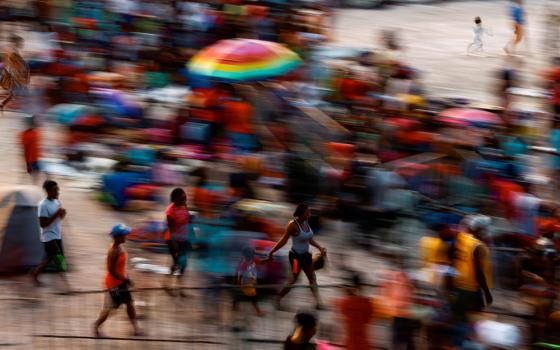 Migrants in Tapachula, Mexico, wait in a stadium Dec. 3, 2021, as they hope to receive help from the Mexican government to obtain humanitarian visas to transit Mexico. (CNS/Reuters/Jose Luis Gonzalez)