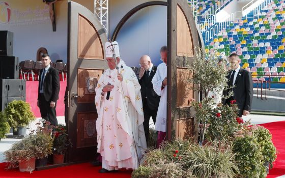 Pope Francis walks through a Holy Door as he arrives to celebrate Mass at Mikheil Meskhi Stadium in Tbilisi, Georgia, in this Oct. 1, 2016. (CNS photo/Paul Haring)