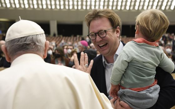 Pope Francis greets Christopher Lamb, Rome correspondent for The Tablet, during his general audience in the Paul VI hall at the Vatican Feb. 16, 2022. (CNS photo/Vatican Media)
