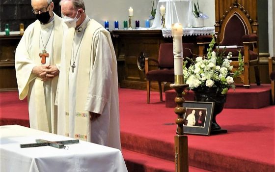 Canadian Cardinal Michael Czerny and Bishop Gary Gordon of Victoria, British Columbia, stand near the coffin of retired Victoria Bishop Remi De Roo during his funeral Mass at St. Andrew's Cathedral in Victoria Feb. 12, 2022. (CNS photo/Kevin Doyle, for Ca