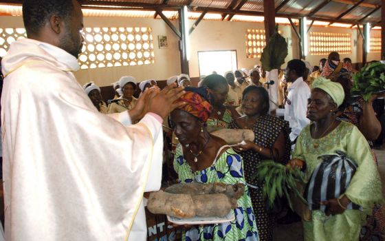 A priest is pictured in a file photo accepting offertory gifts during Mass at St. Therese of the Child Jesus Catholic Church in Yaounde, Cameroon. (CNS photo/Saabi, Galbe.Com)
