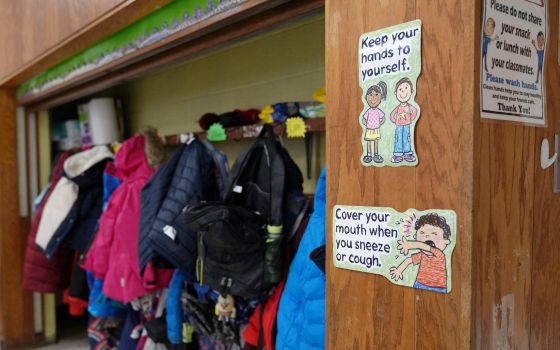 Signs at South Boston Catholic Academy in Boston remind children of precautions to prevent the spread of COVID-19 in the classroom Jan. 28, 2021. (CNS photo/Allison Dinner, Reuters)