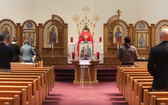 People pray during a morning Divine Liturgy at the Ukrainian Catholic National Shrine of the Holy Family in Washington Feb. 24 after Russia invaded Ukraine. (CNS/Bob Roller)