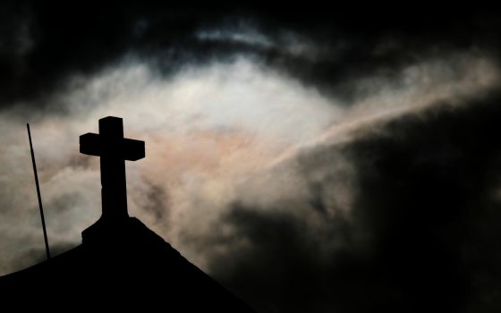 A cross on top of St. Mary Magdalene Chapel, on Dingli Cliffs, is pictured as clouds obscure the sun outside the village of Dingli, Malta, in this Jan. 14, 2022, (CNS photo/Darrin Zammit Lupi, Reuters)