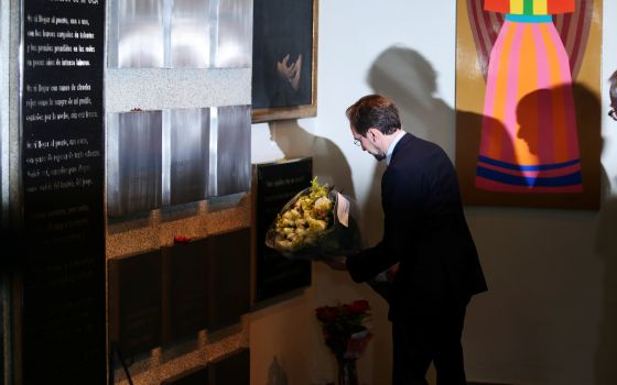 U.N. High Commissioner for Human Rights Zeid Ra'ad Al Hussein places flowers beneath plaques commemorating the six Jesuit priests and two employees killed in 1989, at the Central American University in San Salvador, El Salvador, Nov. 16, 2017. (CNS photo/