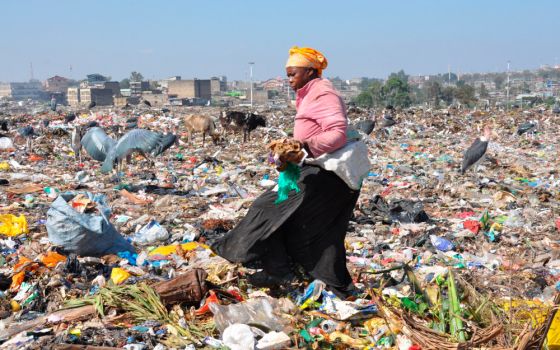 An unidentified woman collects items at the Dandora dumpsite in Nairobi, Kenya, Feb. 26, 2022. The dump attracts poor urban residents who collect recyclable materials for sale. (CNS/Fredrick Nzwili)