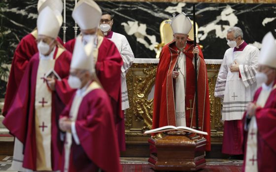 Pope Francis stands at the casket of Italian Cardinal Agostino Cacciavillan after leading the rite of final commendation during the cardinal's funeral Mass in St. Peter's Basilica at the Vatican March 7, 2022. (CNS photo/Paul Haring)
