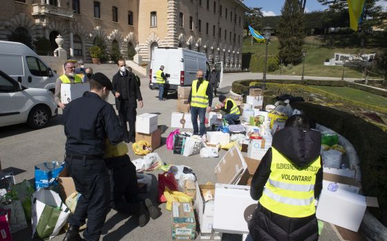 People sort donations from Vatican employees for Ukraine outside the Governatorato, a building housing the Vatican's governing offices, at the Vatican March 7, 2022. (CNS photo/Vatican Media)