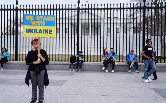 A woman near the White House in Washington holds a sign during a March 6 protest against Russia's invasion of Ukraine. (CNS/Reuters/Sarah Silbiger)