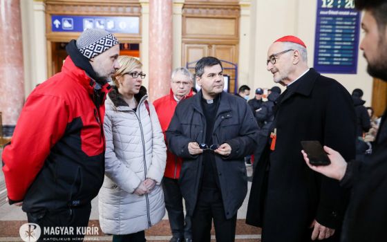 Canadian Cardinal Michael Czerny, interim president of the Dicastery for Promoting Integral Human Development, talks with people during a visit to meet with Ukrainian refugees arriving at the Keleti train station in Budapest, Hungary, March 8, 2022. (CNS 