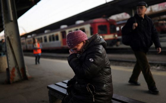 A Ukrainian refugee at North Railway Station in Bucharest, Romania, cries as she says goodbye to a family member March 14, 2022, following the Russian invasion of Ukraine. (CNS photo/Edgard Garrido, Reuters)