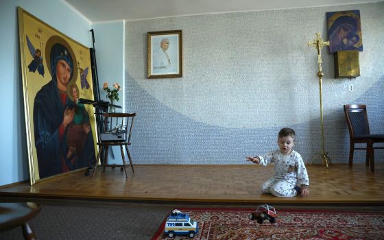 A Ukrainian boy plays at the residence of Father Roman Karpowicz in Lubaczow, Poland, March 21, 2022. (CNS photo/Kacper Pempel, Reuters)