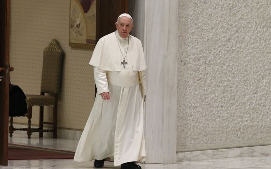 Pope Francis arrives to lead his general audience in the Paul VI hall at the Vatican March 23. (CNS/Paul Haring)