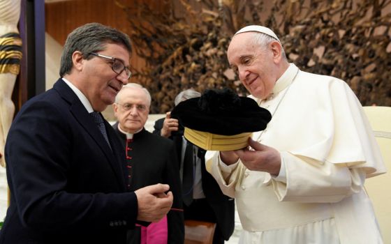 David Ermini, vice president of Italy's High Council of the Judiciary, presents Pope Francis with a judge's hat during a meeting with members of the high council in Paul VI hall at the Vatican April 8, 2022. (CNS/Vatican Media)