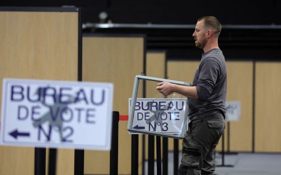 A worker carries a ballot box as he prepares the polling station in Le Touquet-Paris-Plage, France, April 6, for the April 10 presidential election. (CNS/Reuters/Pascal Rossignol)