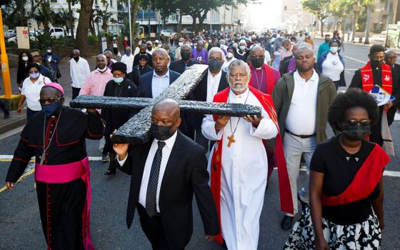 Clergymen carry a large cross during a Good Friday procession in Durban, South Africa, April 15. (CNS/Reuters/Rogan Ward)