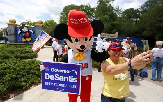 : A person outside Walt Disney World in Orlando, Florida, wears a mouse costume and takes selfies with supporters of Florida's Parental Rights in Education law April 16. (CNS/Reuters/Octavio Jones)