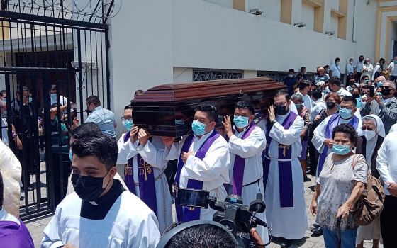 Priests carry the coffin of Archbishop Fernando Saenz Lacalle to the crypt of the cathedral of San Salvador, El Salvador, May 2.