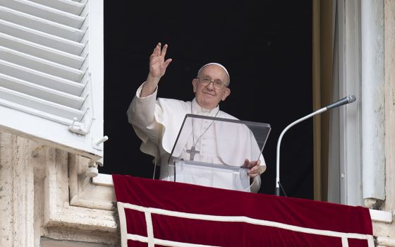 Pope Francis greets the crowd as he leads the "Regina Coeli" prayer from the window of his studio overlooking St. Peter's Square May 8 at the Vatican. (CNS/Vatican Media)