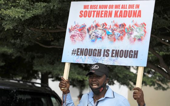 A man holds up a sign against killings in southern Kaduna state and insecurities in Nigeria during a protest in Abuja Aug. 15, 2020. (CNS photo/Afolabi Sotunde, Reuters)
