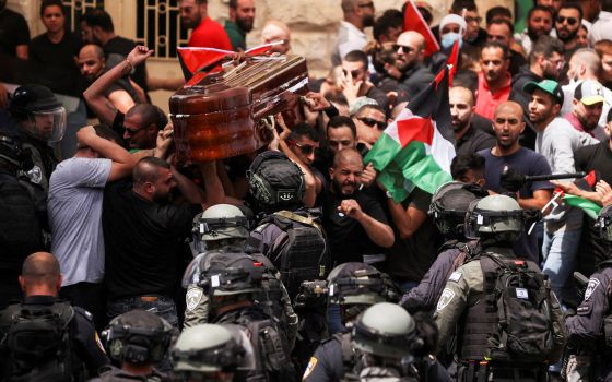 Israeli riot police scuffle with mourners carrying the casket of Al-Jazeera journalist Shireen Abu Akleh during a procession in Jerusalem's Old City May 13, 2022. (CNS photo/Ammar Awad, Reuters)