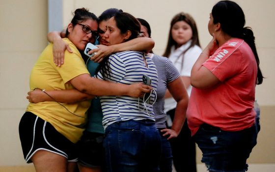 People react outside the SSGT Willie de Leon Civic Center, where students had been transported from Robb Elementary School after a shooting, in Uvalde, Texas, May 24, 2022. (CNS photo/Marco Bello, Reuters)