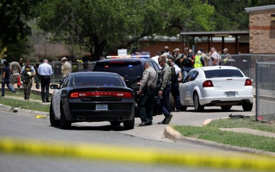 Law enforcement officers guard the scene of a shooting at Robb Elementary School in Uvalde, Texas, May 24. (CNS/Reuters/Marco Bello)