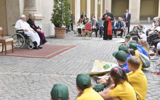 Pope Francis listens as Cardinal Gianfranco Ravasi, president of the Pontifical Council for Culture, speaks during an audience with some 160 children in the San Damaso Courtyard at the Vatican June 4. (CNS/Vatican Media)