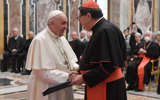 Pope Francis greets Brazilian Cardinal João Braz de Aviz, prefect of the then-Congregation for Institutes of Consecrated Life and Societies of Apostolic Life, during an audience at the Vatican Dec. 11, 2021. (CNS/Vatican Media)