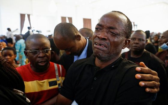 A man cries during a funeral Mass in the parish hall of St. Francis Xavier Church in Owo, Nigeria, June 17. The Mass was for at least 50 victims killed in a June 5 attack by gunmen during Mass at the church. (CNS/Reuters/Temilade Adelaja)