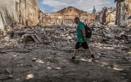 A local resident walks in a front of a building destroyed by a Russian military airstrike in a photo taken June 17 in Lysychansk, Ukraine. (CNS/Reuters/Oleksandr Ratushniak)