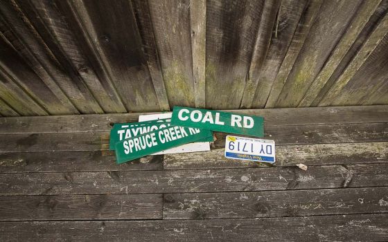 Road signs rest on the side porch of a house near Kermit, West Virginia, Aug. 20, 2014. The Supreme Court ruled in West Virginia v. Environmental Protection Agency on June 30, 2022, to limit EPA's ability to regulate carbon emissions from power plants.