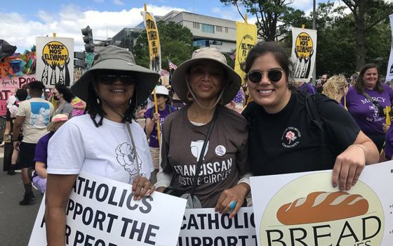 Charlene Howard, chairwoman of the Pax Christi USA national council, Josie Garnem, a national council member, and Lauren Bailey, the organization's national field organizer, pose during a demonstration June 18 in Washington. (CNS)
