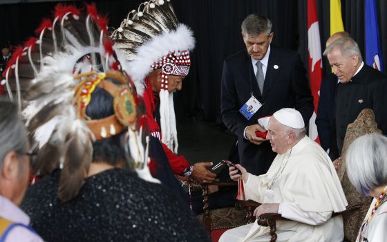 Pope Francis is welcomed by Indigenous leaders during a welcoming ceremony at Edmonton International Airport July 24. The pope was beginning a six-day visit to Canada. (CNS/Paul Haring)
