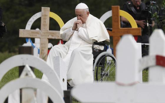 Pope Francis prays at the Ermineskin Cree Nation Cemetery before meeting with First Nations, Métis and Inuit communities July 25 at Maskwacis, Alberta. (CNS/Paul Haring)